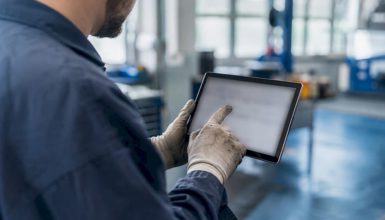 Technician assigning work orders on a dark tablet screen
