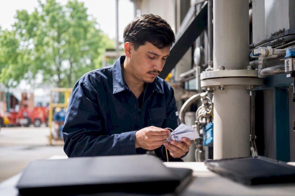 Technician organizing asset labels in workshop