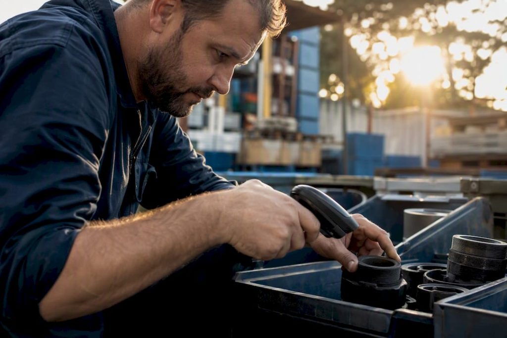 Technician hands scanning maintenance inventory barcodes