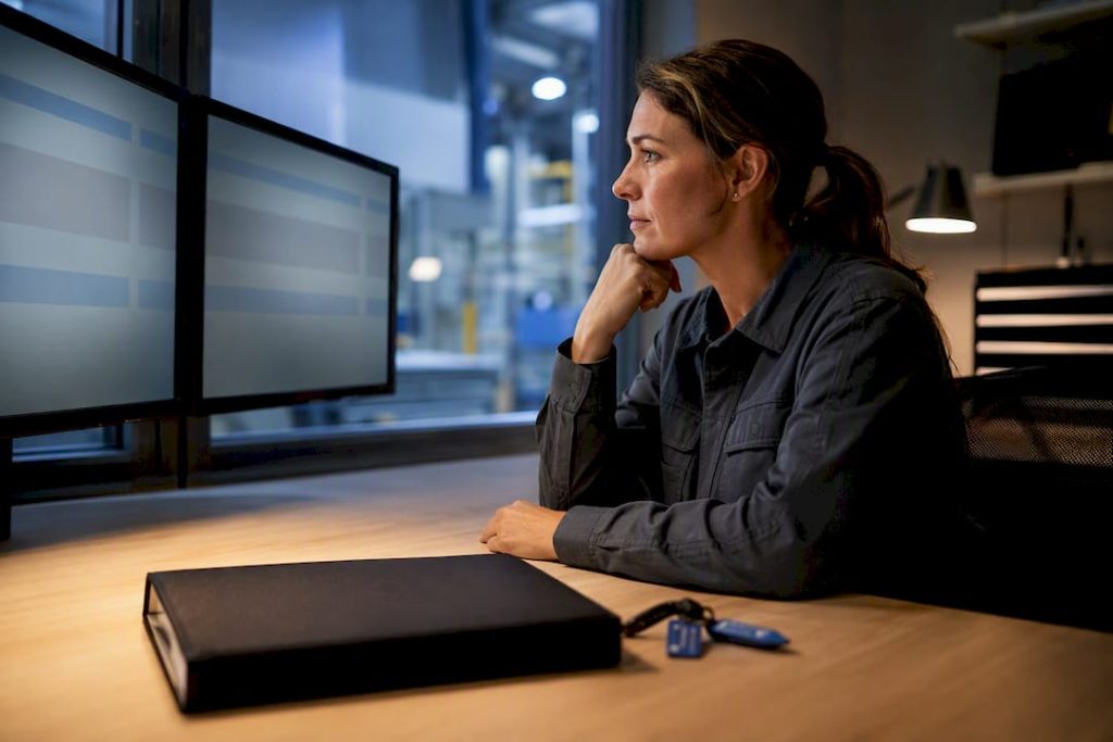 Maintenance coordinator comparing parallel CMMS workflows